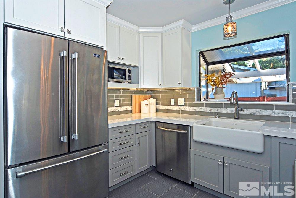 2390 Riviera Street Reno, NV 89509 - Photo 5 of 19 a kitchen with appliances a sink and cabinets