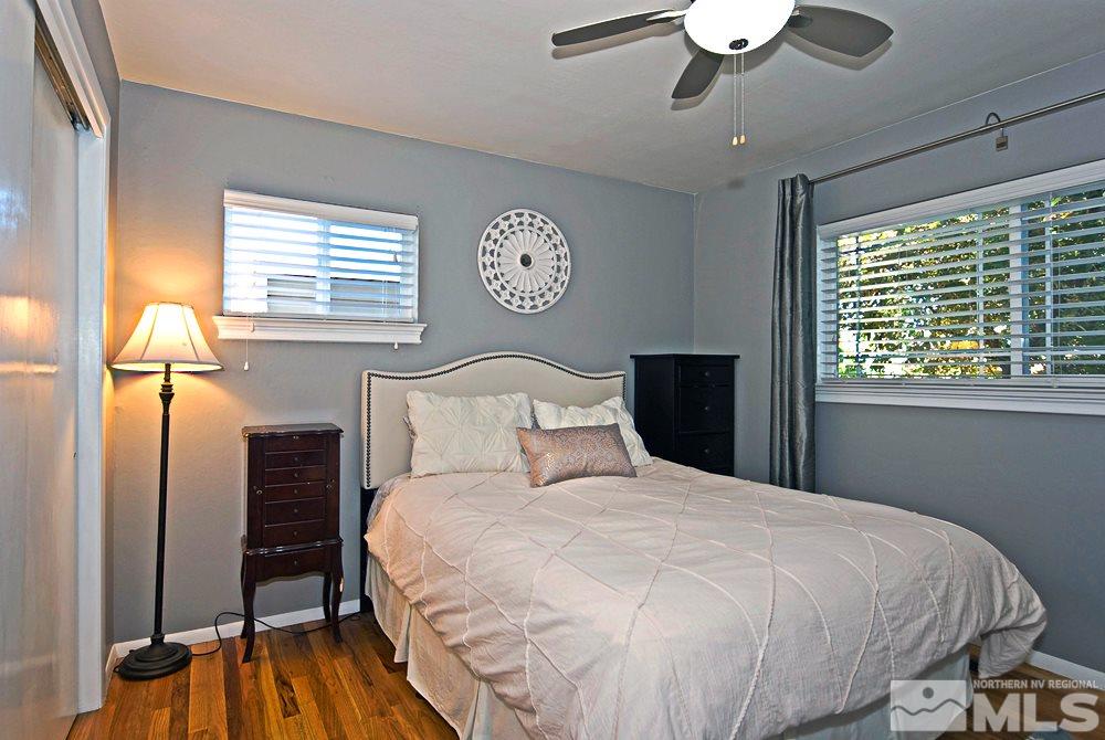 2390 Riviera Street Reno, NV 89509 - Photo 8 of 19 a bedroom with a bed and a chandelier