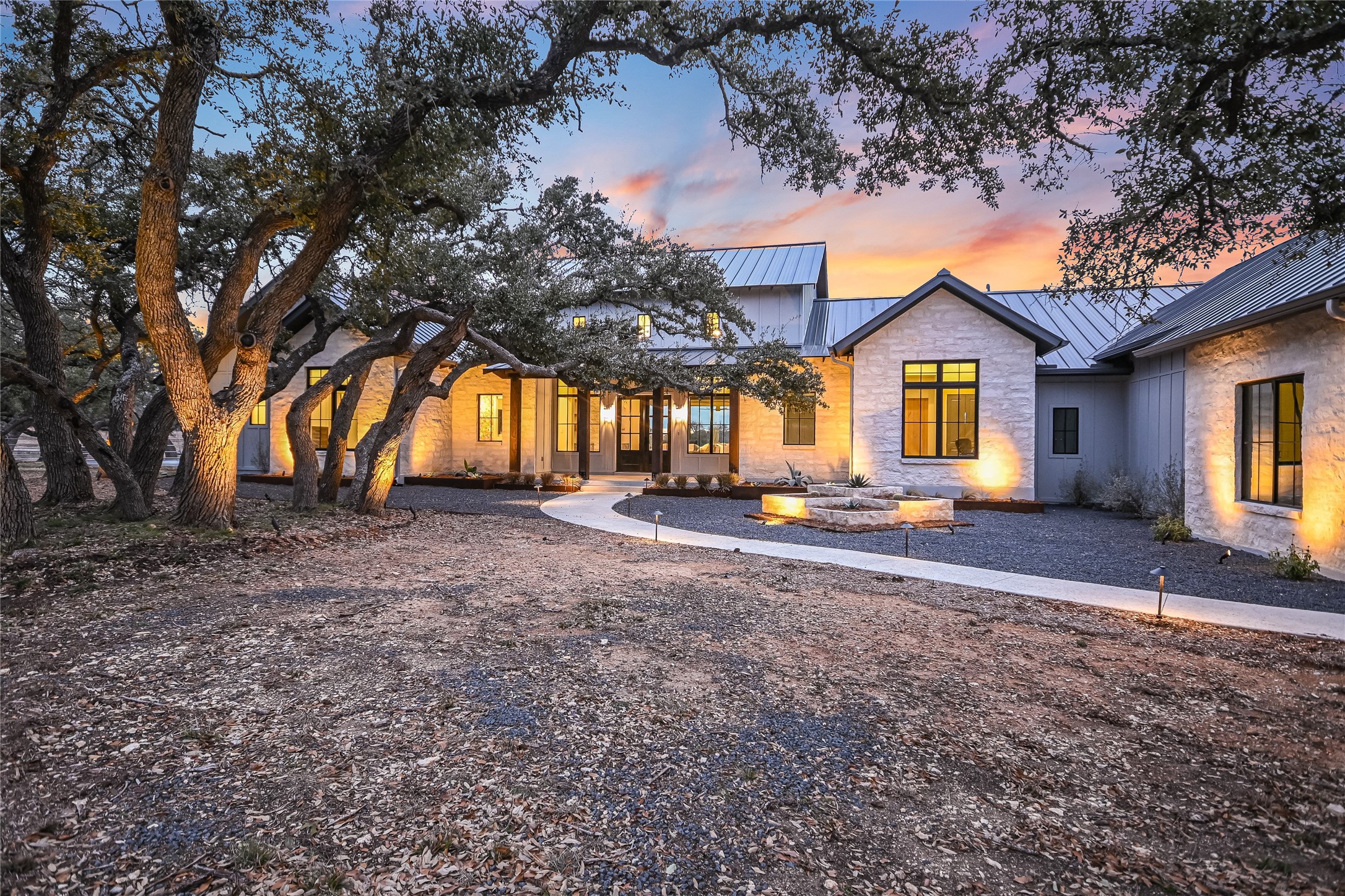 207 Gwendolyns Trail Wimberley, TX 78676 - Photo 3 of 40 a front view of house with yard and trees around
