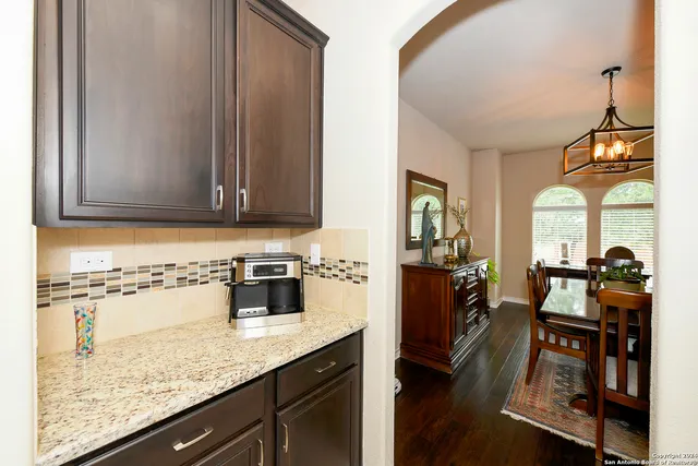 a kitchen with a refrigerator and a stove top oven