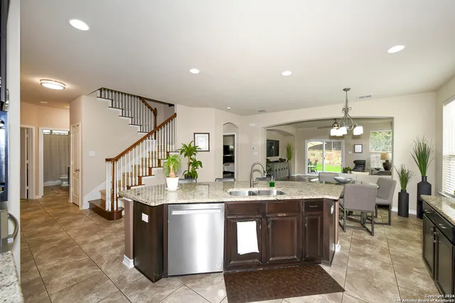 a room with lots of wooden furniture and a chandelier