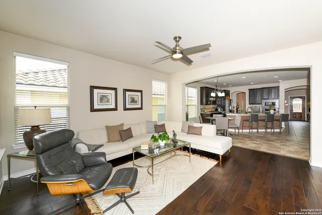 a living room with furniture and wooden floor