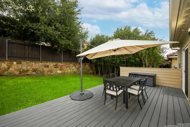a view of backyard with seating space and trees