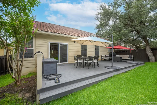 a view of house with backyard and outdoor seating