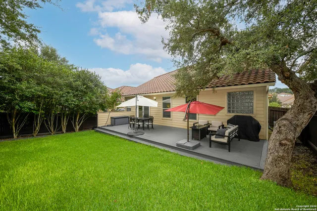 a view of a house with backyard porch and sitting area