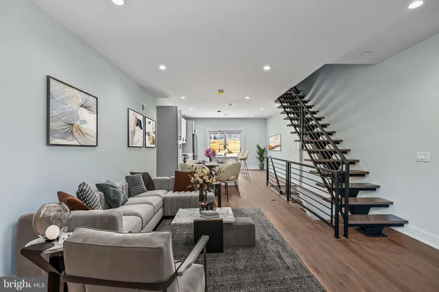a living room with furniture and a potted plant