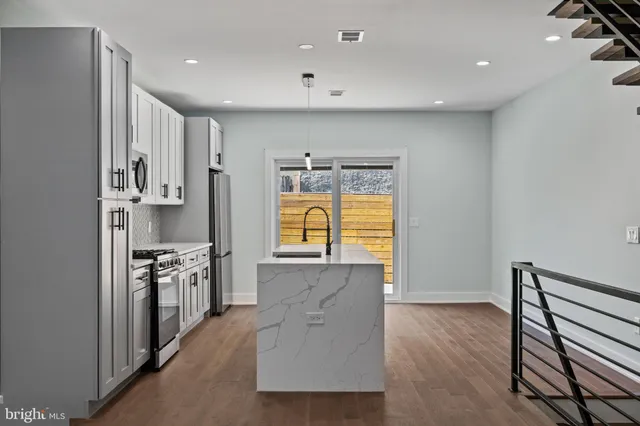 a kitchen with stainless steel appliances granite countertop a stove and a refrigerator