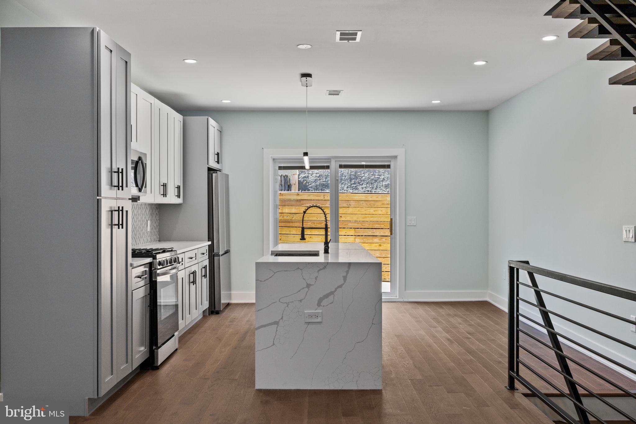 2202 East Huntingdon Street Philadelphia, PA 19125 - Photo 12 of 42 a kitchen with stainless steel appliances granite countertop a stove and a refrigerator