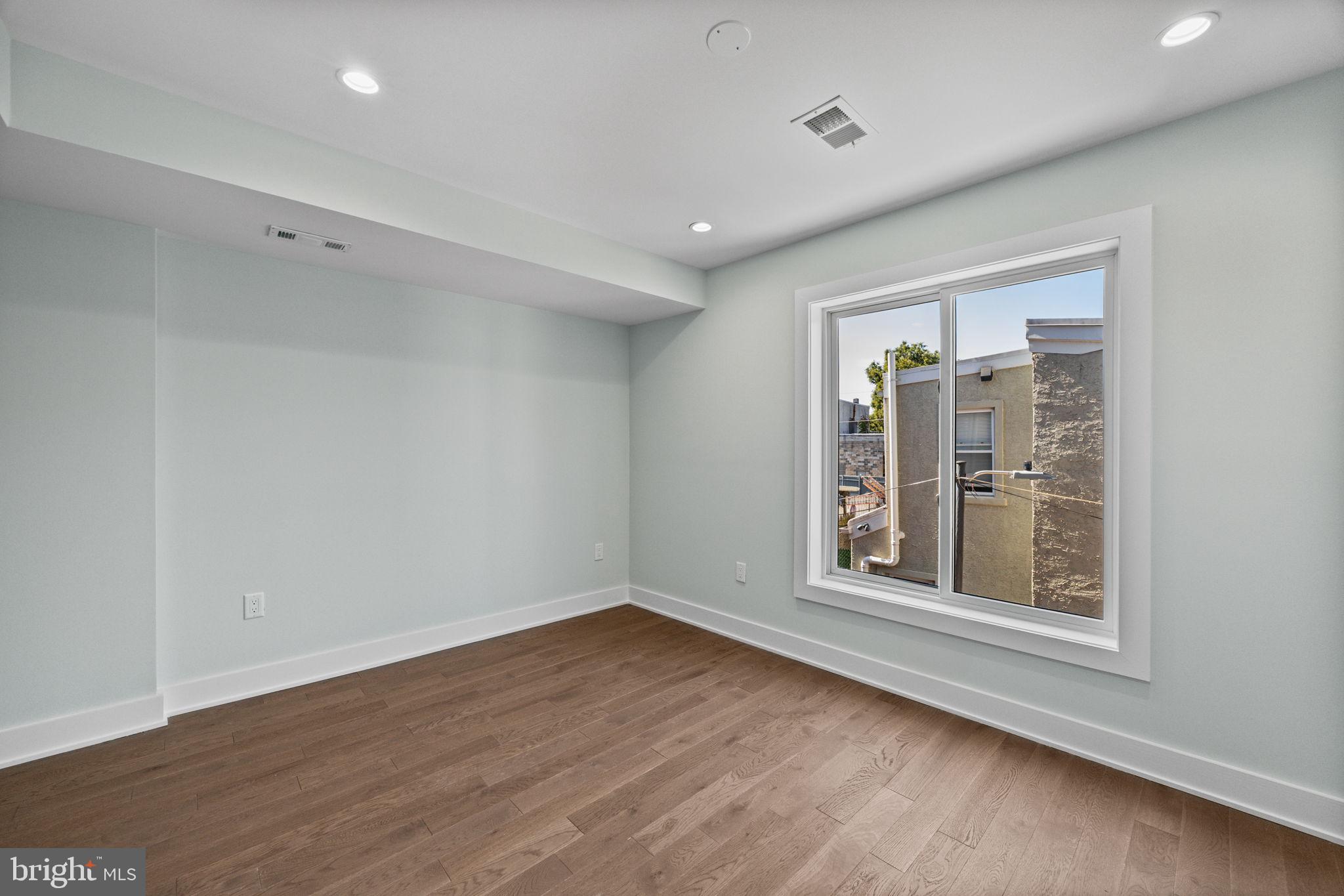 2202 East Huntingdon Street Philadelphia, PA 19125 - Photo 14 of 42 a view of an empty room with wooden floor and a window