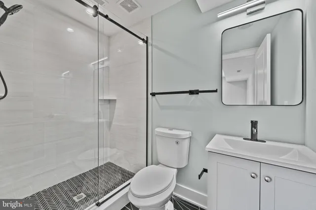 a bathroom with a toilet a sink and shower
