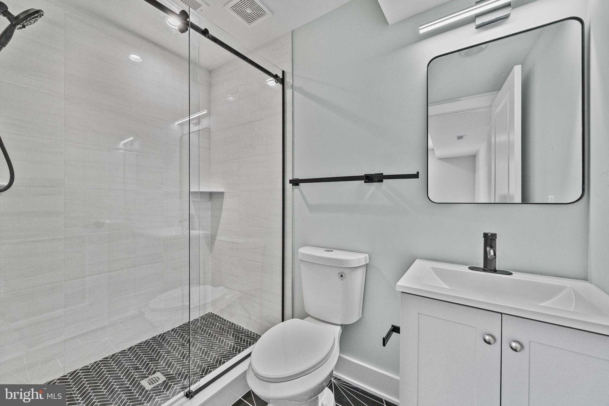 2202 East Huntingdon Street Philadelphia, PA 19125 - Photo 16 of 42 a bathroom with a toilet a sink and shower