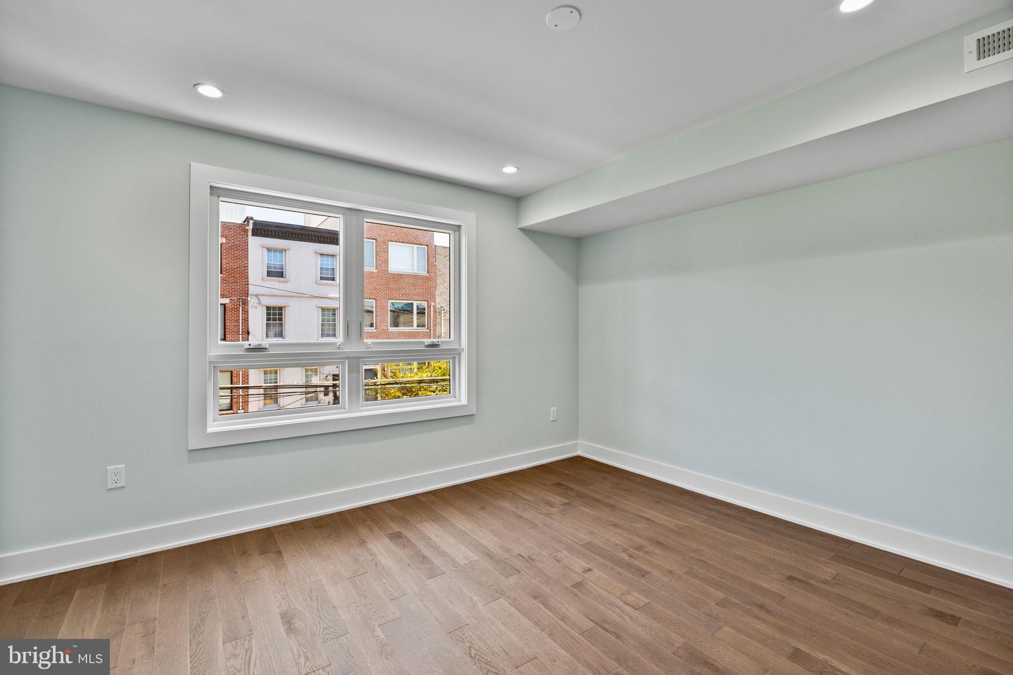 2202 East Huntingdon Street Philadelphia, PA 19125 - Photo 18 of 42 a view of an empty room with wooden floor and a window