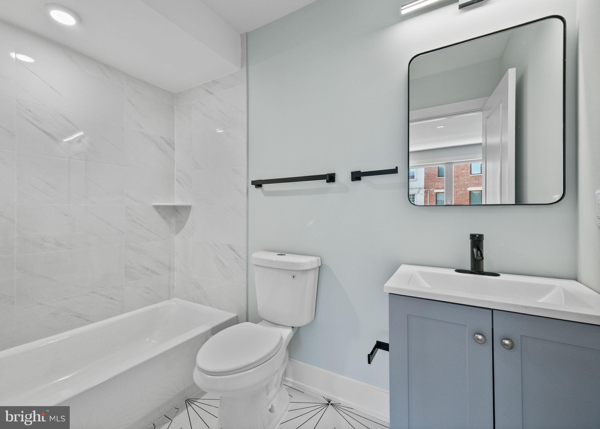 2202 East Huntingdon Street Philadelphia, PA 19125 - Photo 20 of 42 a bathroom with a sink a toilet and a mirror