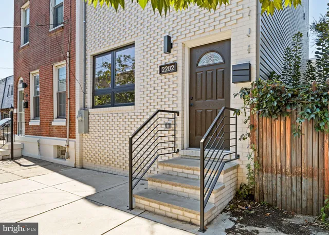 a view of front door of house with stairs
