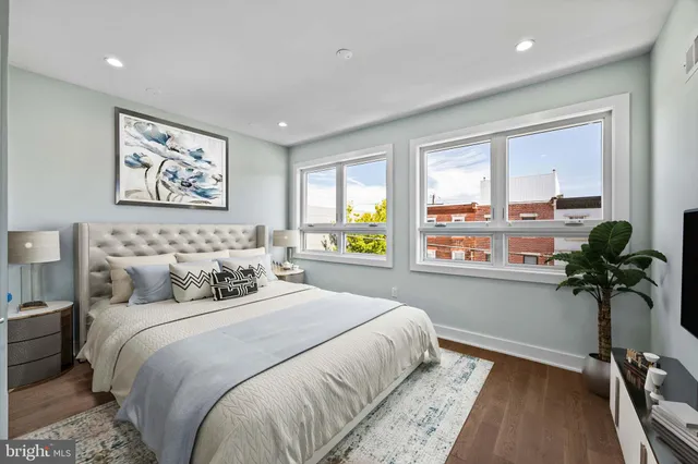 a bedroom with bed and a large window