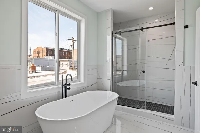 a bathroom with a bathtub and a shower