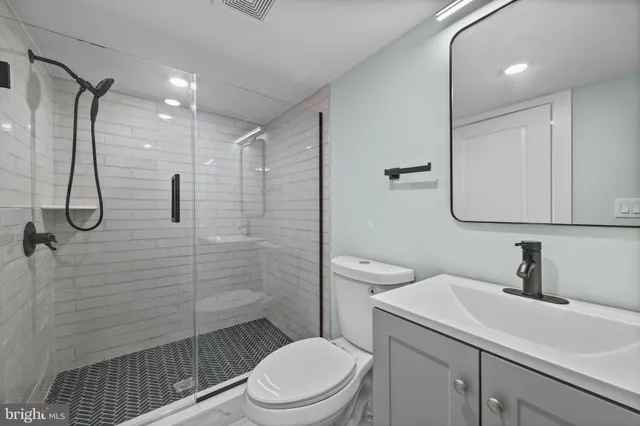 a bathroom with a sink toilet and shower