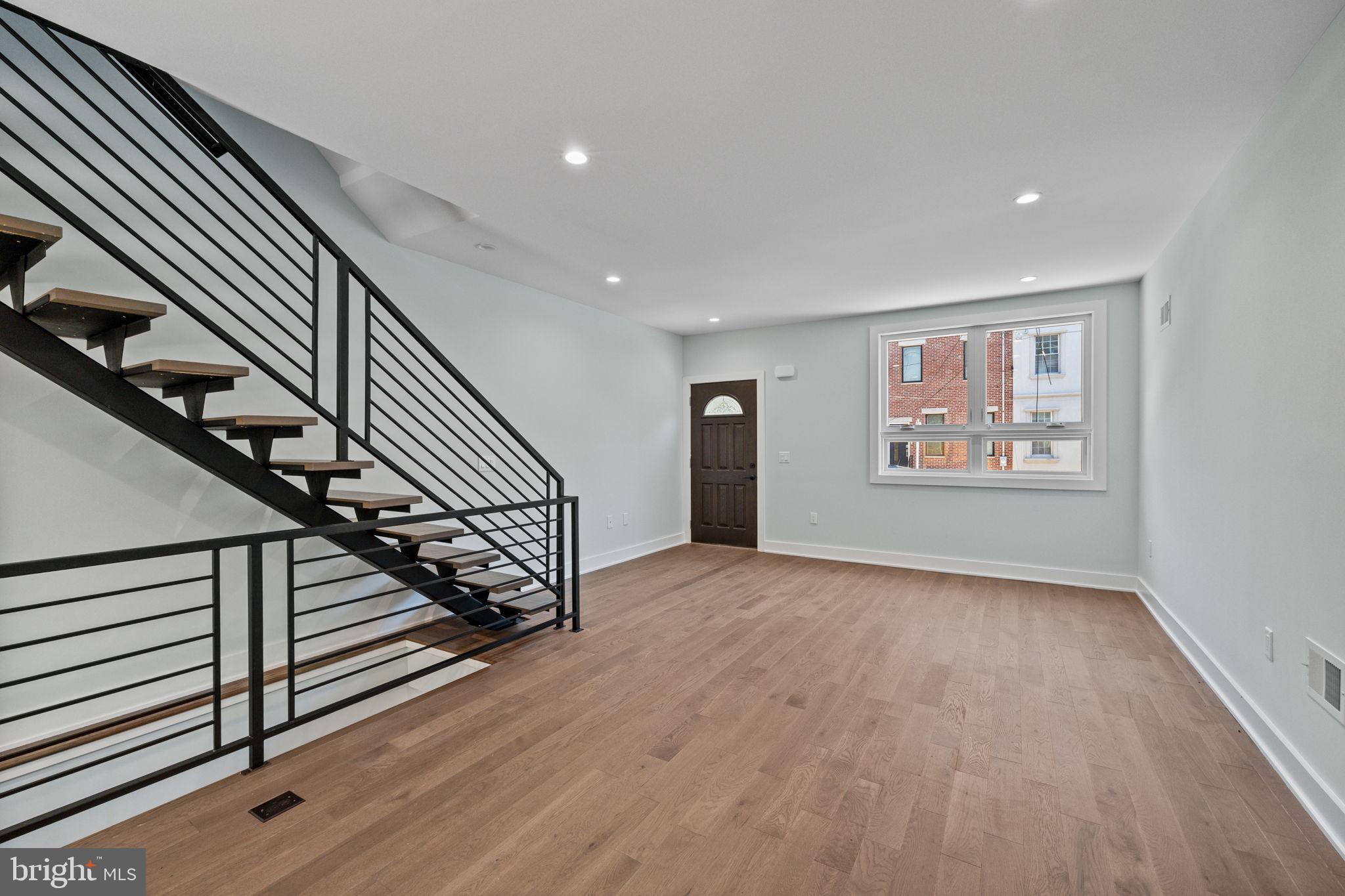 2202 East Huntingdon Street Philadelphia, PA 19125 - Photo 5 of 42 a view of an empty room with wooden floor stairs