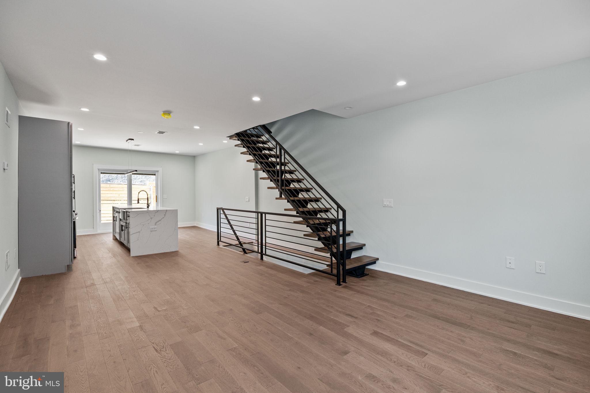 2202 East Huntingdon Street Philadelphia, PA 19125 - Photo 6 of 42 a view of an empty room with wooden floor and a window