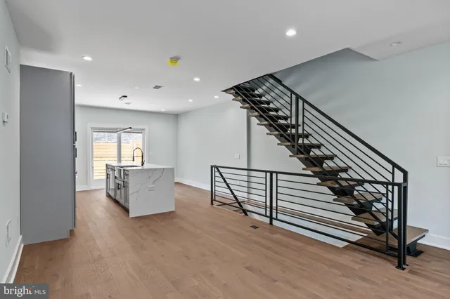 a view of entryway and hall with wooden floor