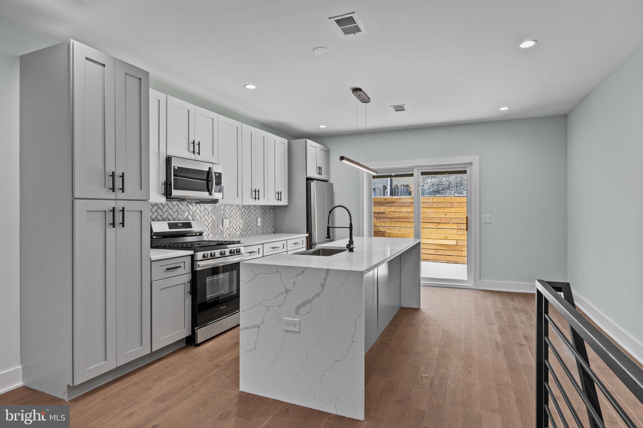 2202 East Huntingdon Street Philadelphia, PA 19125 - Photo 8 of 42 a kitchen with kitchen island a sink stainless steel appliances and cabinets