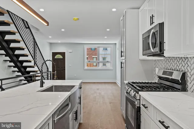 a kitchen that has a sink and a stove
