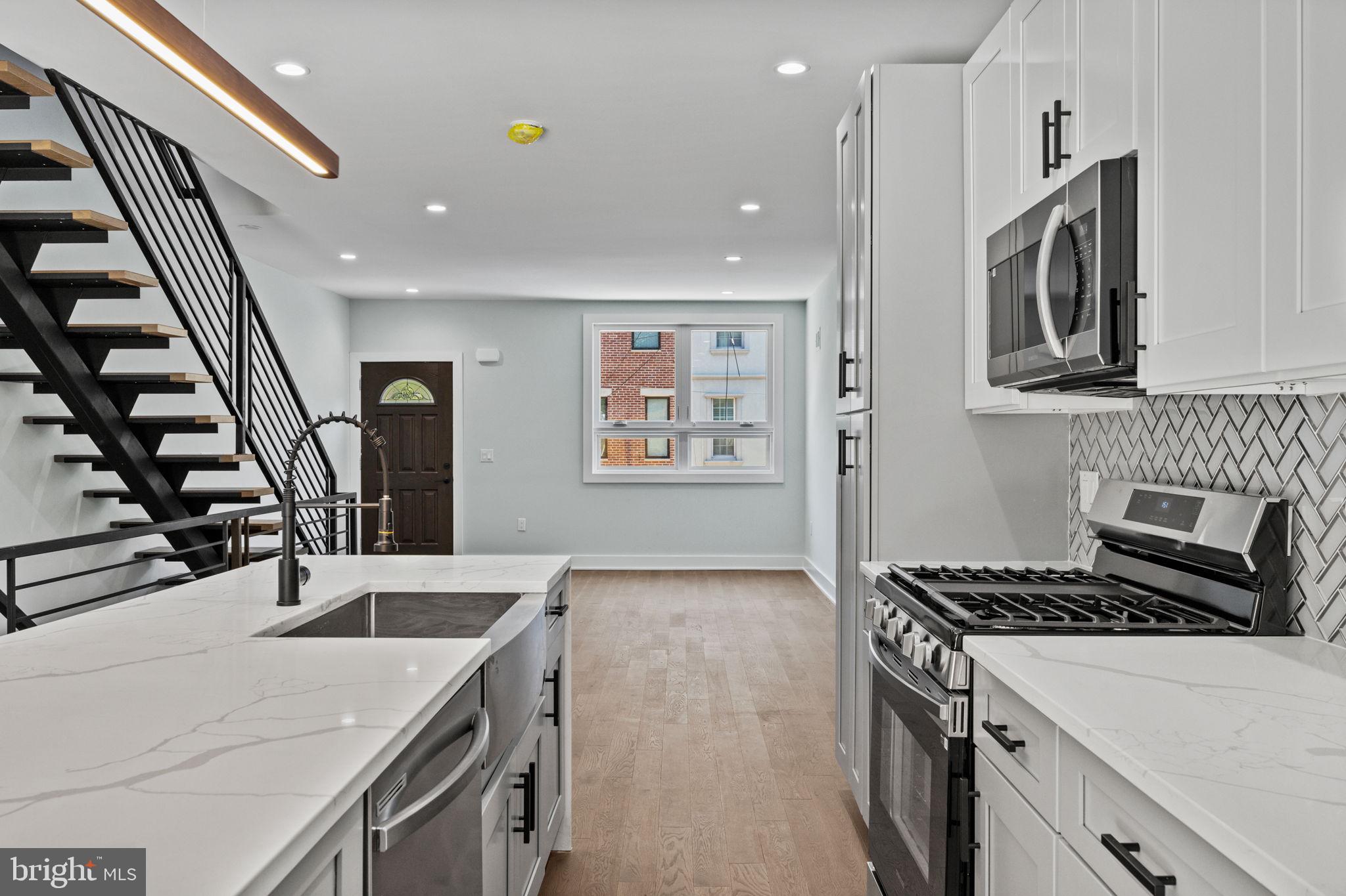 2202 East Huntingdon Street Philadelphia, PA 19125 - Photo 9 of 42 a kitchen that has a sink and a stove