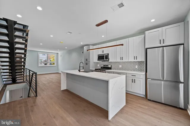 a kitchen with refrigerator and cabinets