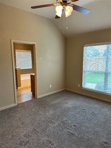 a bathroom with a granite countertop sink and a bathtub