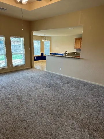 a kitchen with stainless steel appliances a stove a sink a microwave a refrigerator a counter top space and cabinets