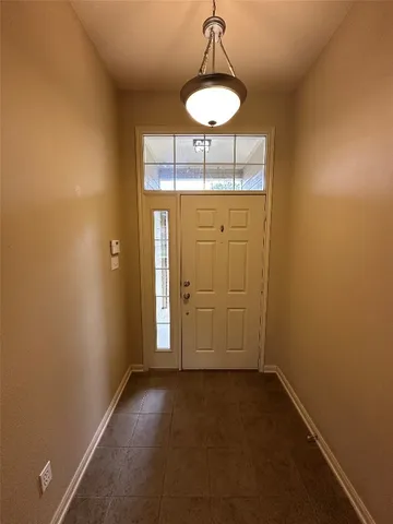a view of a room with a chandelier fan