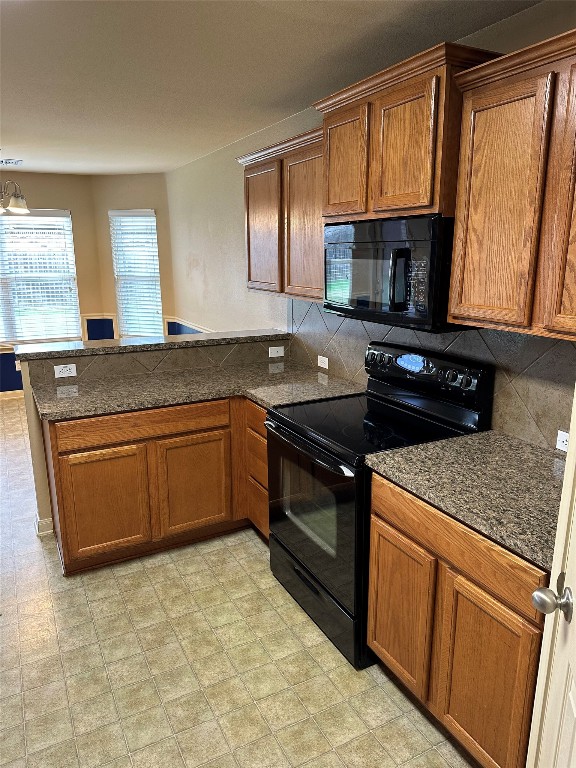 7518 Amber Meadow Loop Temple, TX 76502 - Photo 25 of 35 a kitchen with stainless steel appliances granite countertop a stove a sink and a microwave