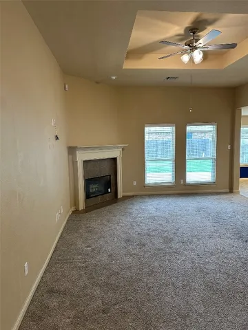 a view of empty room with a fireplace