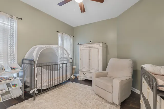 a bedroom with two beds and a chandelier