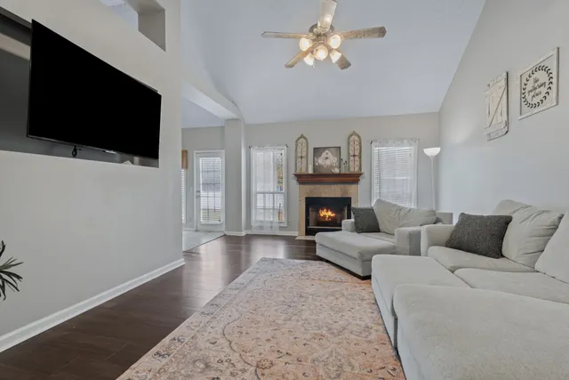 a living room with furniture and a fireplace