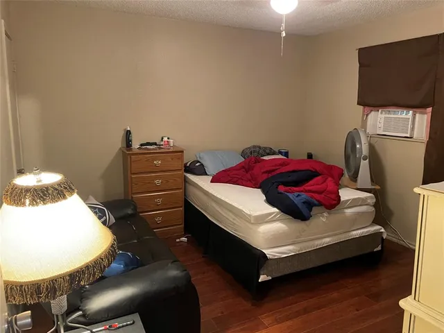 a bedroom with a bed and a television