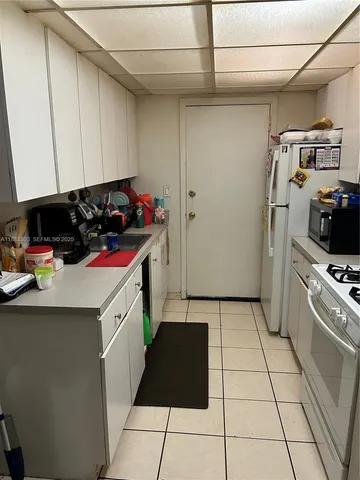 a kitchen with a sink a stove and refrigerator