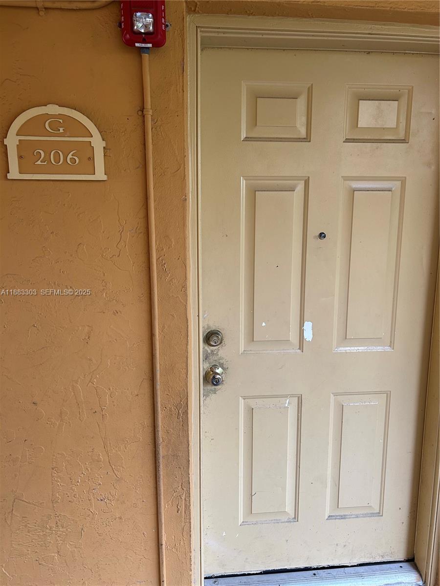 18111 Northwest 68th Avenue, Unit G206 Hialeah, FL 33015 - Photo 9 of 30 a view of a door