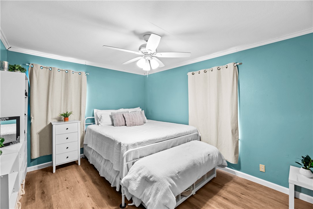 9505 County Road 505 Mathis, TX 78368 - Photo 12 of 19 a bedroom with a bed and a chandelier