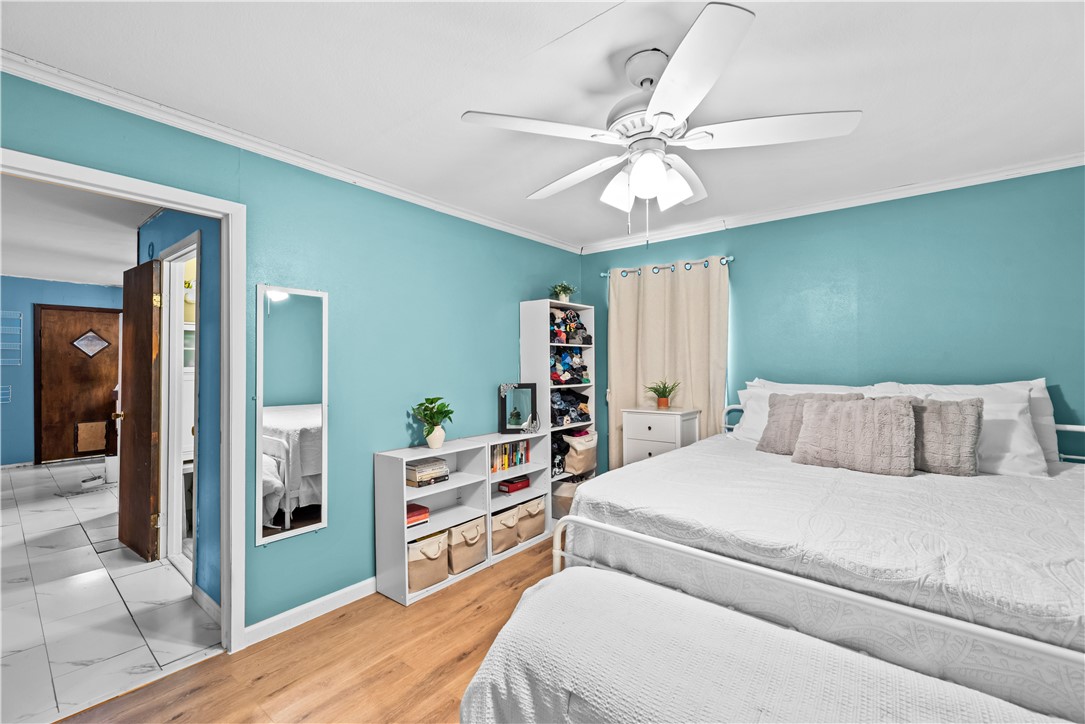 9505 County Road 505 Mathis, TX 78368 - Photo 13 of 19 a bedroom with a large bed and a chandelier