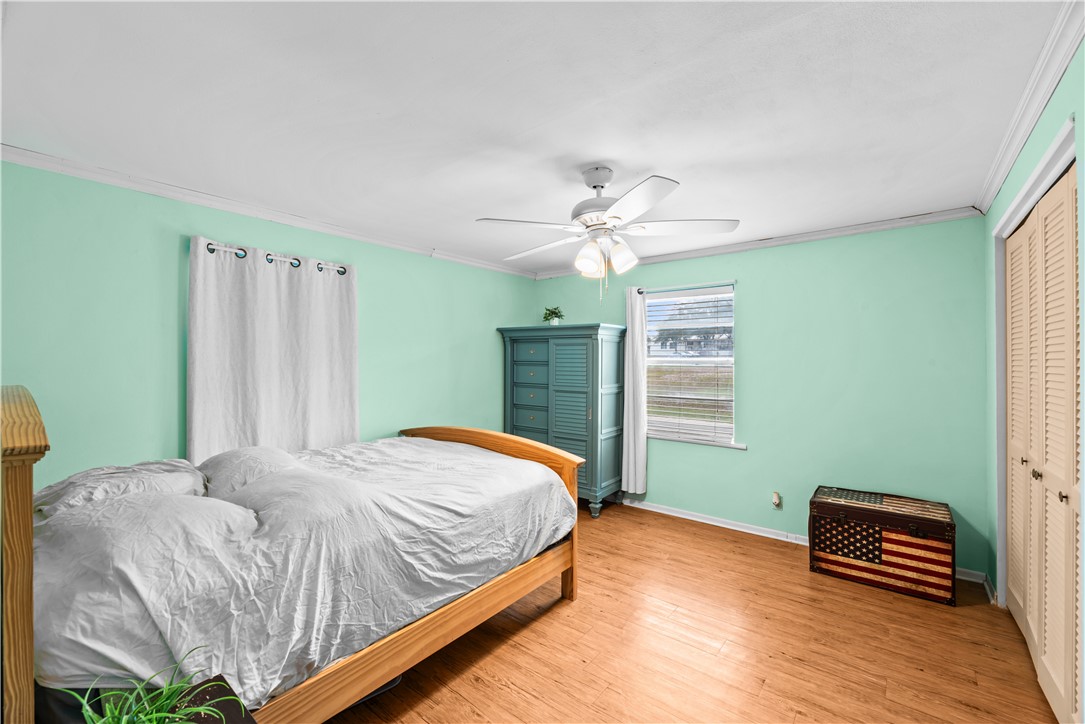 9505 County Road 505 Mathis, TX 78368 - Photo 14 of 19 a bedroom with a bed and a chandelier