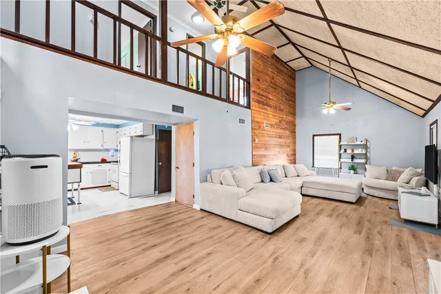 a bedroom with furniture and wooden floor