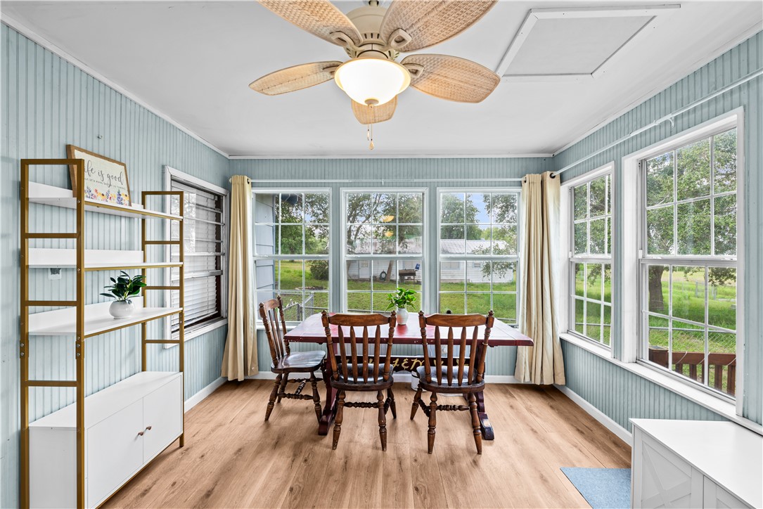 9505 County Road 505 Mathis, TX 78368 - Photo 6 of 19 a dining room with furniture a chandelier and wooden floor