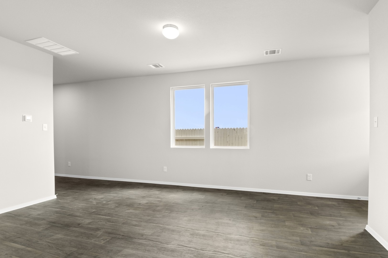 2963 Winding Creek Road Kyle, TX 78640 - Photo 11 of 28 a view of an empty room with wooden floor and a window
