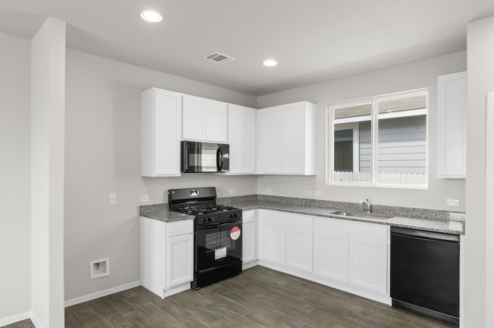 2963 Winding Creek Road Kyle, TX 78640 - Photo 17 of 28 a kitchen with granite countertop a sink and steel appliances