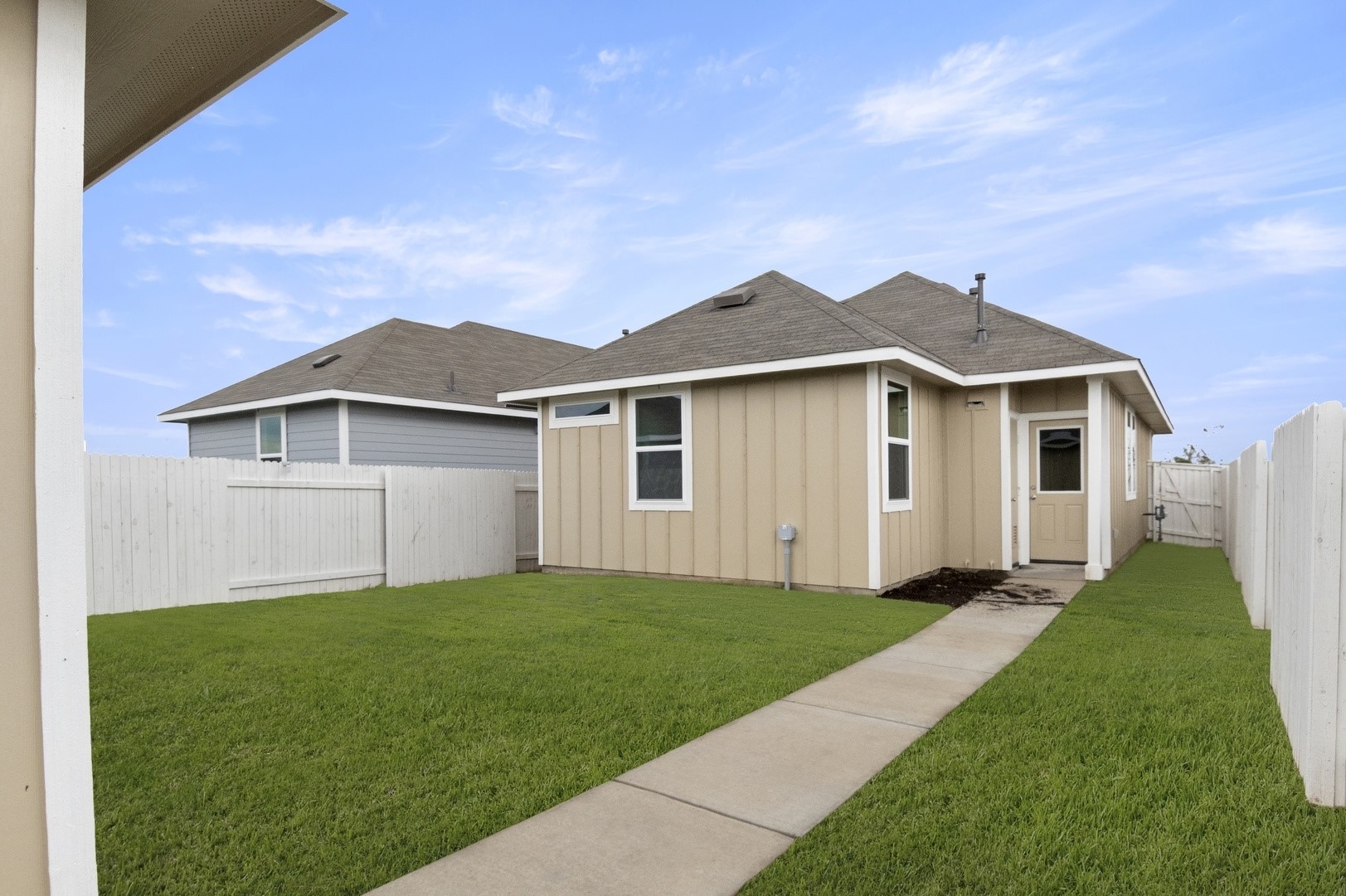 2963 Winding Creek Road Kyle, TX 78640 - Photo 26 of 28 a front view of a house with a yard and garage