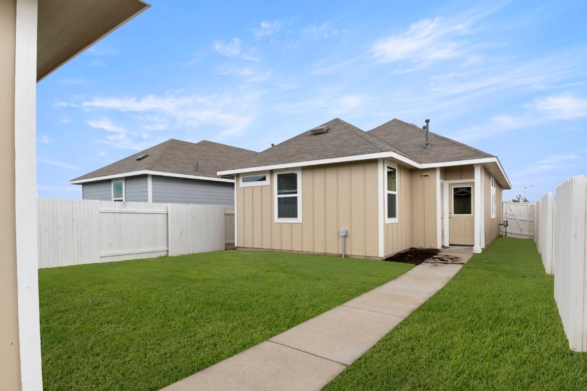 2963 Winding Creek Road Kyle, TX 78640 - Photo 26 of 28 a front view of a house with a yard and garage