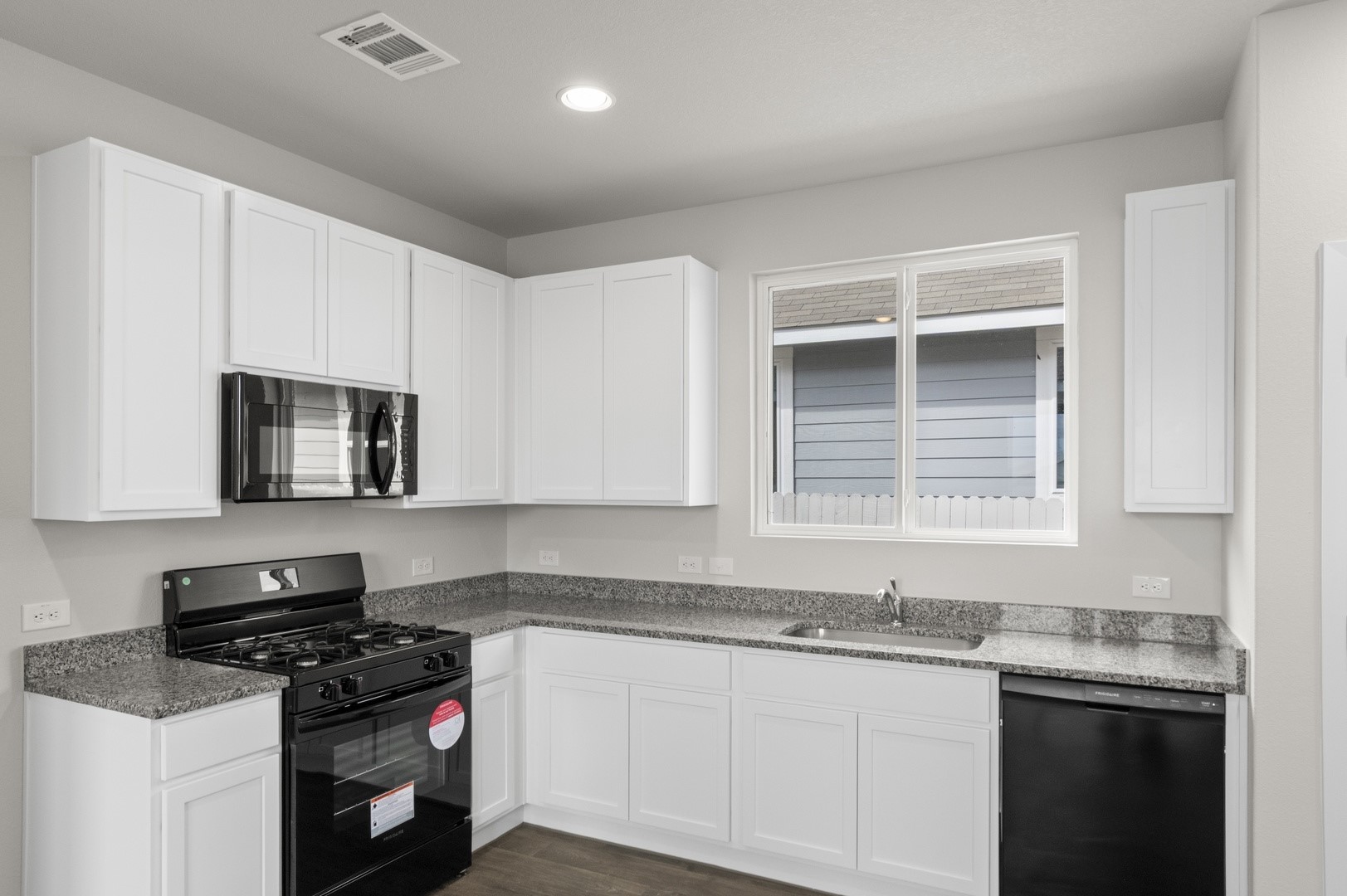 2963 Winding Creek Road Kyle, TX 78640 - Photo 8 of 28 a kitchen with stainless steel appliances granite countertop a sink stove and cabinets