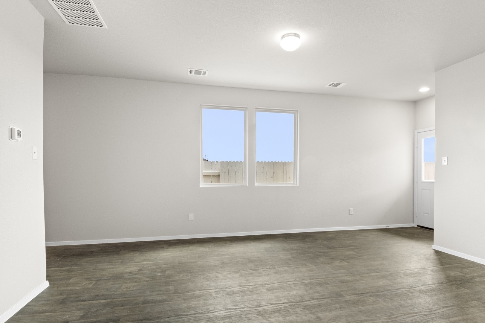 2963 Winding Creek Road Kyle, TX 78640 - Photo 9 of 28 a view of a room with wooden floor and window