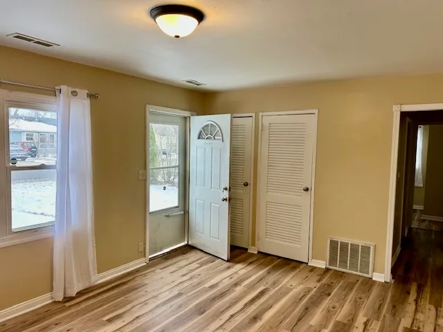 a view of a livingroom with wooden floor and closet